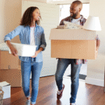two people with moving boxes in home