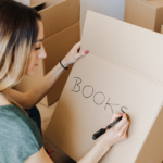 moving boxes being labeled by woman Metropolitan Moving & Storage