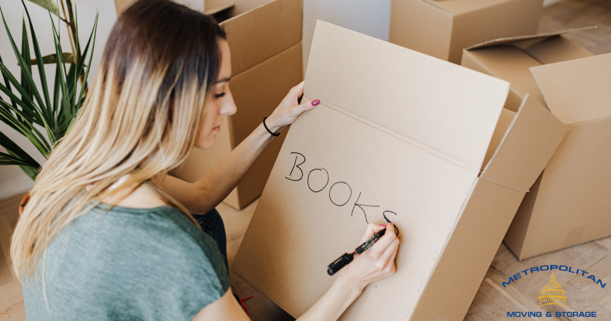 moving boxes being labeled by woman Metropolitan Moving & Storage