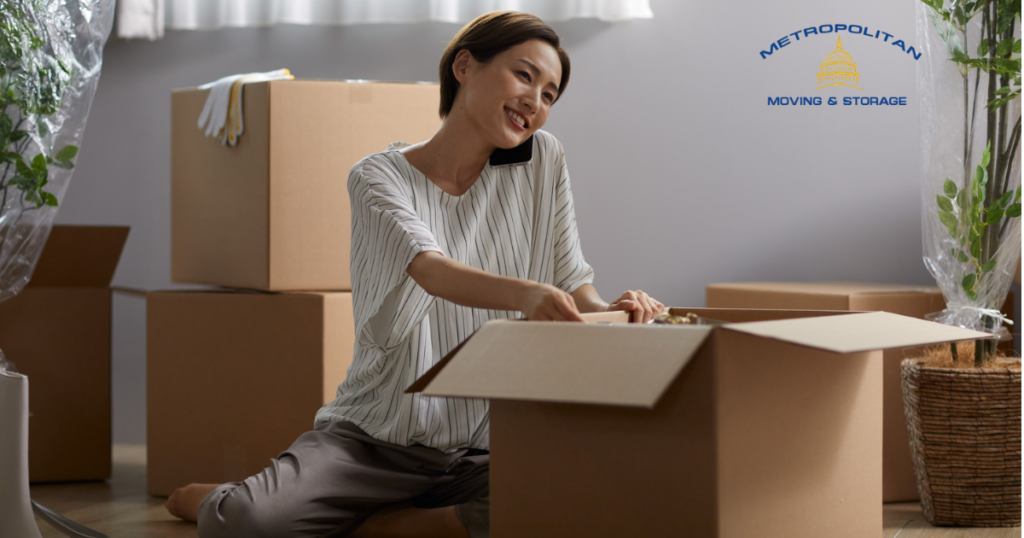 woman packing a box for moving Metropolitan Moving & Storage