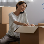 woman packing a box for moving Metropolitan Moving & Storage