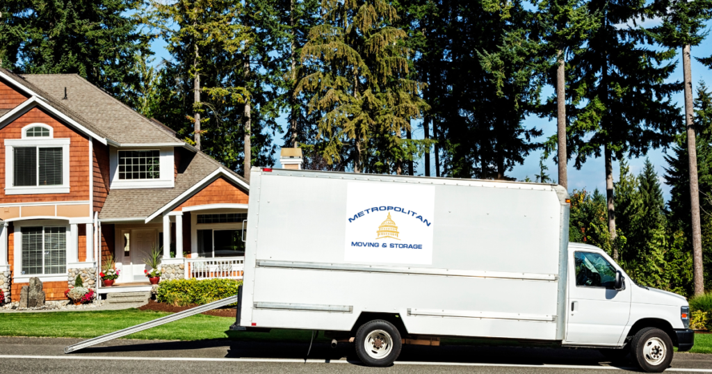 moving truck in front of house Metropolitan Moving & Storage