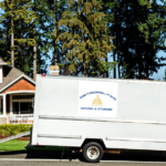 moving truck in front of house Metropolitan Moving & Storage